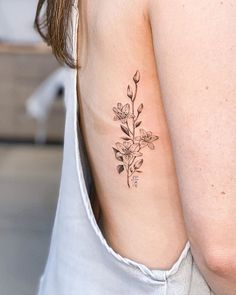 a woman with a flower tattoo on her chest