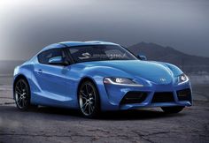 a blue sports car parked in front of a mountain