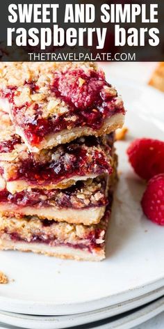 raspberry bars stacked on top of each other with strawberries in the background