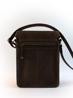 "Unisex messenger bag made of 1.8 - 2.0 mm thick dark chocolate brown Crazy Horse cow leather, lined with impregnated cotton fabric. Leather straps are underlaid with cotton belt. That way it's stronger, and the leather won't get stretched out or sweaty and stained, or dry and cracked from coming on contact with skin. Stylish and special bag, perfect for everyday wear. Can include 9.7\" iPad, A5 size document, etc FEATURES: - main compartment with twist lock closure - front pocket with snap butt Brown Leather Trim Shoulder Bag For Everyday, Brown Oiled Leather Shoulder Satchel, Brown Waxed Finish Crossbody Satchel, Brown Oiled Leather Shoulder Bag, Brown Oiled Leather Shoulder Bag For Everyday, Dark Chocolate Brown, Leather Messenger Bag, Crazy Horse, Leather Material