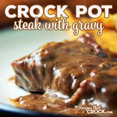 crock pot steak with gravy on a white plate next to fried potatoes