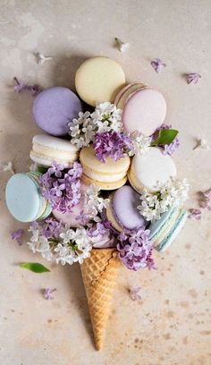 an ice cream cone filled with macaroons and flowers