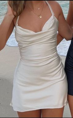 a woman in a white dress on the beach