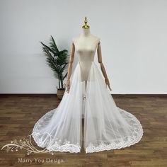 a mannequin wearing a white wedding dress on display