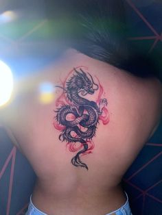 a woman with a dragon tattoo on her back