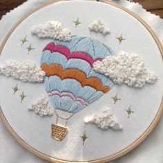 an embroidered hot air balloon flying through the sky