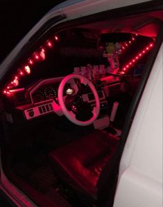 the interior of a car with red lights