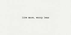 the words live more worry less written in black ink on white paper with an image of a