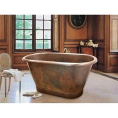 an old fashioned bath tub in a large bathroom