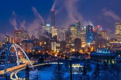 the city skyline is lit up at night