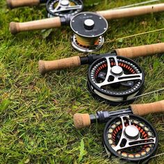 four fishing rods and reels laying on the grass