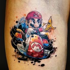 mario kart tattoo on the leg with watercolor splashes and an animal riding in it