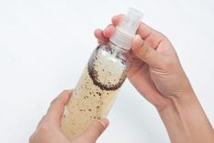 a person holding a bottle with dirt on it