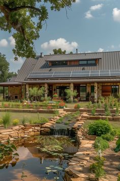 a house with solar panels on the roof and water flowing from it's pond