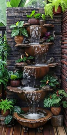 an outdoor fountain with plants surrounding it