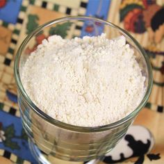 a glass bowl filled with white powder on top of a table