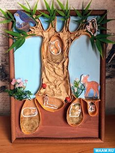 a wooden frame with an image of a tree and shoes on the bottom, surrounded by leaves