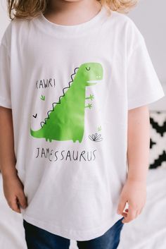 This t-shirt is the perfect gift for any Dinosaur lovers! It would make a great birthday present and general day to day wear. Dinosaur comes in either Pink, Green, yellow or Blue! The item is hand printed with care in our London studio. Feel free to contact us for any custom needs! Please note this is for one t-shirt, all sizes are for children & please double check before placing your order. If unsure just email us for measurements at hello.pom@outlook.com Sizes: 6 - 12 months 1 - 2 years 2 - 3 Green T-shirt With Dinosaur Print For Birthday, Fun Short Sleeve T-shirt With Dinosaur Print, Green Dinosaur Print T-shirt For Summer, Playful Green T-shirt For Birthday, Green Dinosaur Print Summer T-shirt, White T-shirt With Dinosaur Print For Birthday, Green Dinosaur Print T-shirt For Birthday, Birthday Dinosaur Print Short Sleeve T-shirt, Fun Short Sleeve Dinosaur Print T-shirt