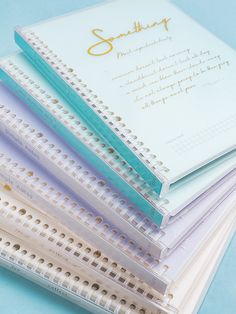 five notebooks stacked on top of each other with the word something written on them