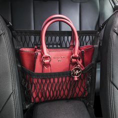 a red purse sitting in the back seat of a car