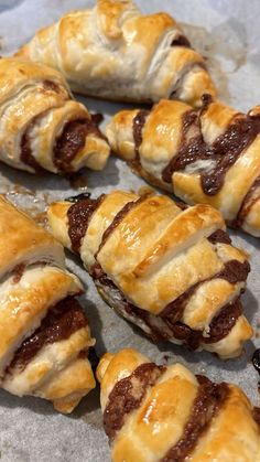 several pastries sitting on top of a piece of wax paper