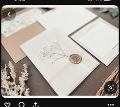 the wedding stationery is laid out on the table