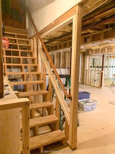 an unfinished room with stairs and construction materials