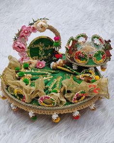 an elaborately decorated basket on a white furnishing with flowers and other decorations