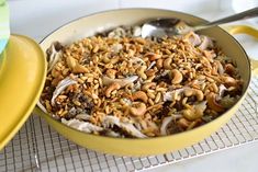 a yellow pan filled with food on top of a table