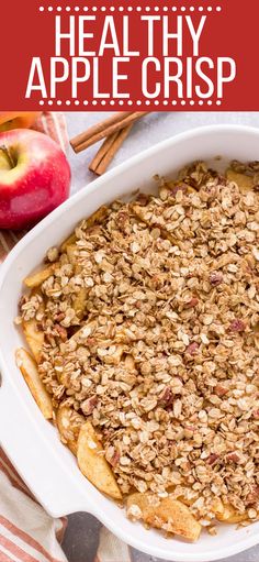 an apple crisp in a white casserole dish with apples and cinnamon sticks on the side