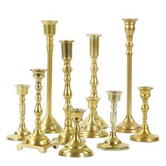 a group of gold candlesticks sitting next to each other