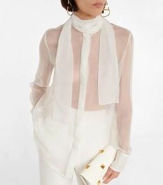 This ethereal blouse from Valentino is made from lightweight and sheer silk chiffon. It has high collar with tie details and buttoned cuffs..Care instructions: dry clean.Closure: concealed buttoned front.Buttoned cuffs.Made in Italy.Material: 100% silk.True to size.For a looser fit, we recommend taking one size up.Sheer.Designed for a loose fit.Lightweight material.Falls below the hip.The model seen in the picture is 178cm-5'10' and wearing a size IT 40 Valentino Silk, Valentino Women, Tie Neck Blouse, Top Collection, Tie Neck, Silk Chiffon, High Collar, Women's Tops, Neck Tie