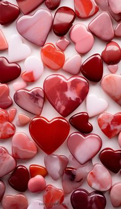 red and pink hearts are arranged in the shape of hearts