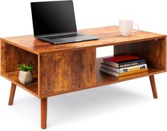 a laptop computer sitting on top of a wooden desk next to a book shelf with books