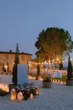 an outdoor wedding venue with candles lit up