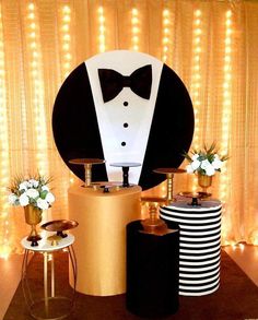 a black and white tuxedo is on display in front of a gold table