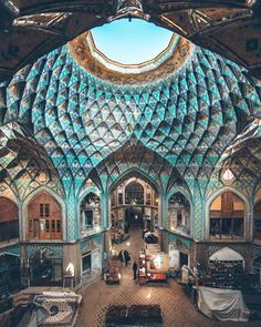 the inside of an old building with lots of blue and green tiles on it's walls