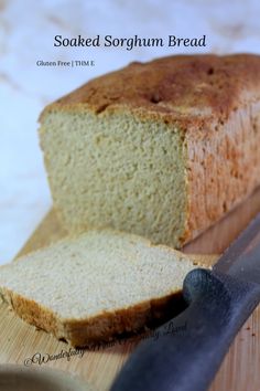 a loaf of bread sitting on top of a cutting board next to a knife