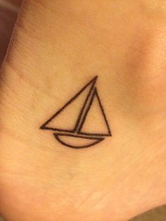 a small sailboat tattoo on the ankle