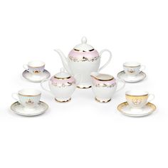 a white tea set with gold trimmings on the rim and saucers in front of it