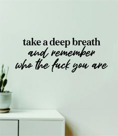 there is a wall decal that says, take a deep breath and remember who the f