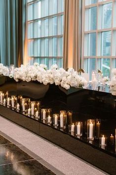 a long table with candles and flowers on it