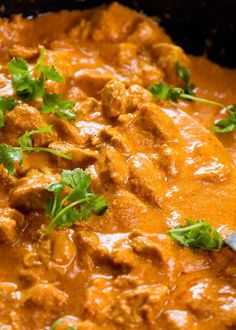 a bowl filled with meat and cilantro sauce