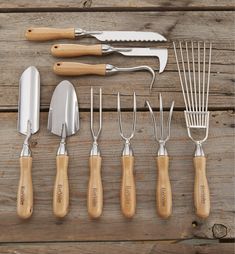 a collection of kitchen utensils and spatulas sitting on top of a wooden table