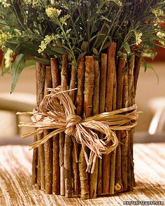 a bunch of sticks wrapped in twine and tied with a bow are sitting on a table