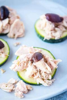 cucumber halves with tuna and olives on them are ready to be eaten