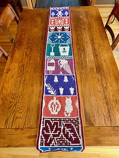 the table runner is on top of a wooden dining room table