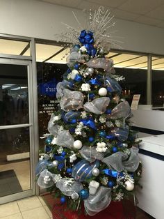 a christmas tree with blue and silver decorations