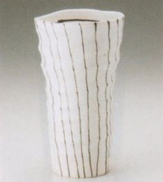 a white vase with black lines on it