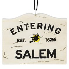 a white sign that says entering salem on it's front and back sides, hanging from a cord